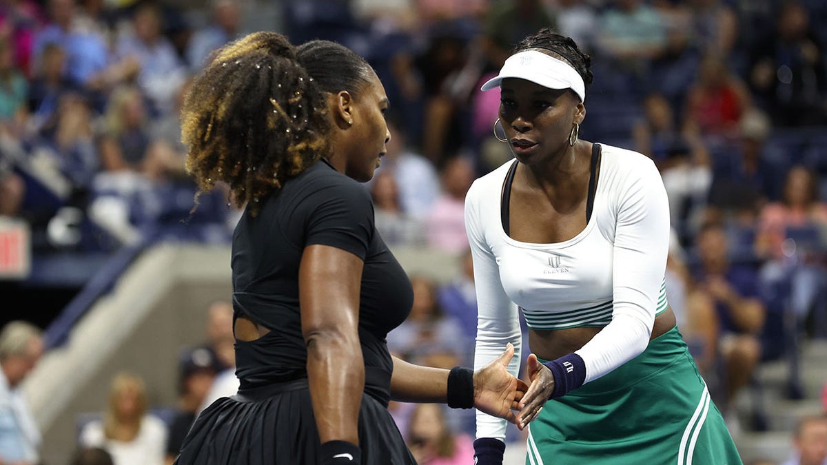 Serena and Venus Williams high five