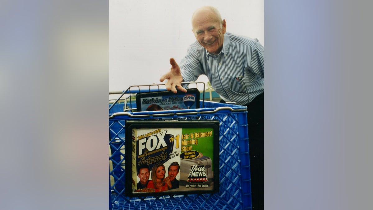 Jim Doocy and a grocery cart with a Fox and Friends ad