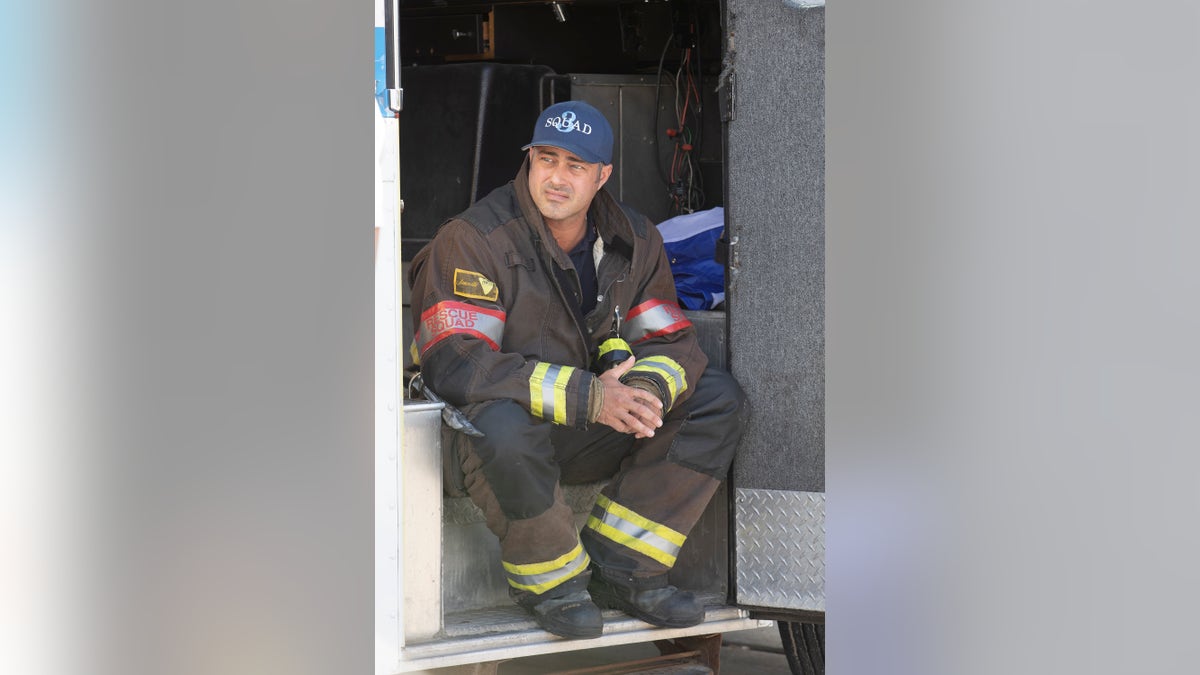 Taylor Kinney sits in the back of an emergency medical vehicle