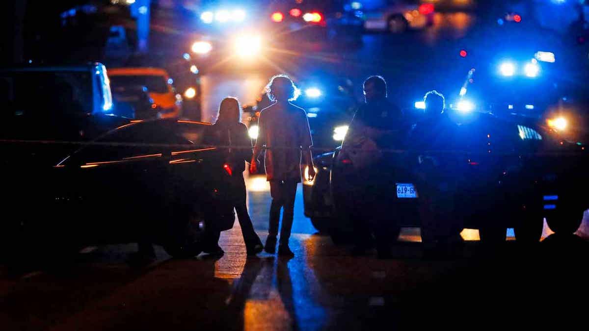 Police officers work at the scene of an active shoote