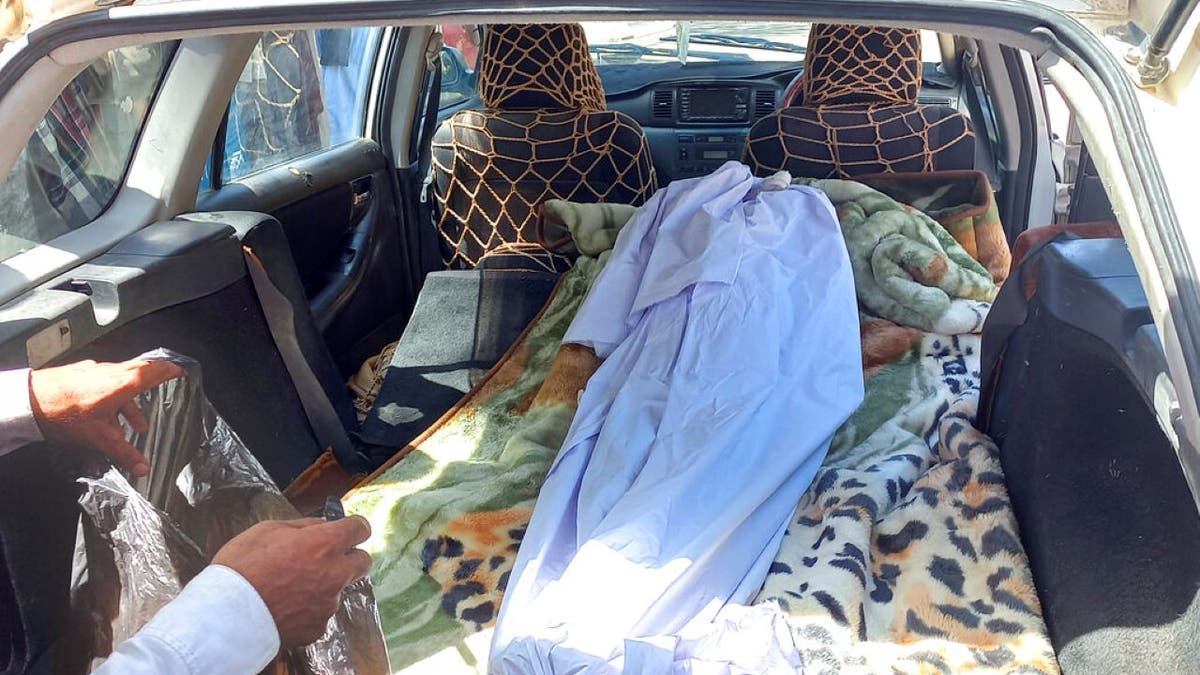 Body of a girl lying in the back of a car after an explosion in Afghanistan