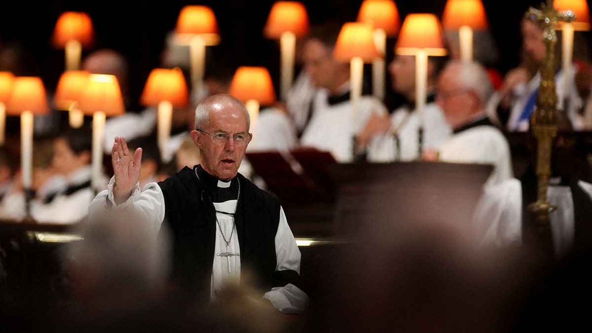 Justin Welby hand raised