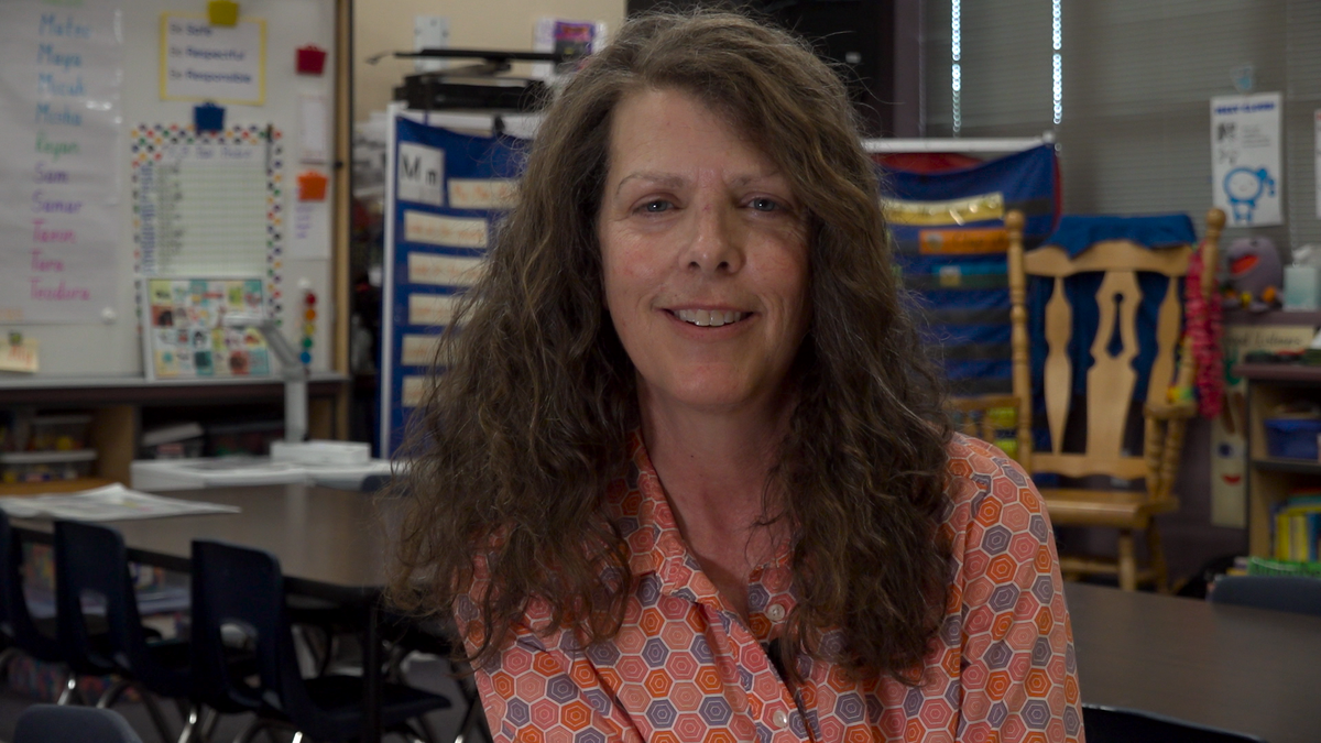 Ms. Arndt sitting in her classroom