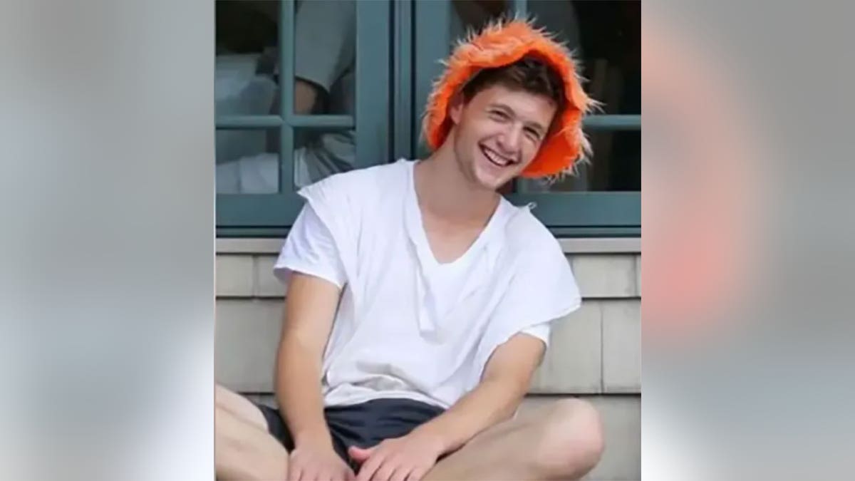 Murder victim Aryeh Wolf smiles in orange hat