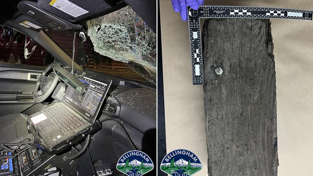 interior of police car with shattered windshield and a railroad tie