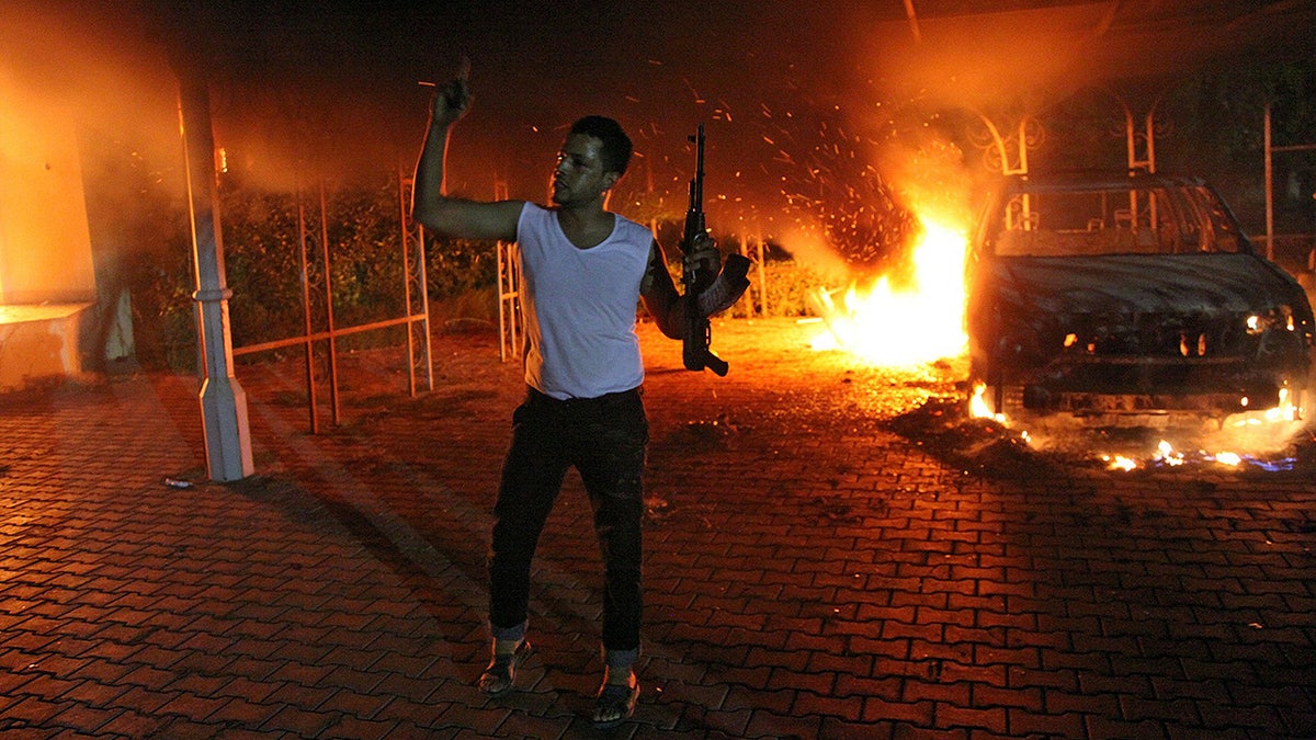 man waves rifle during benghazi attack