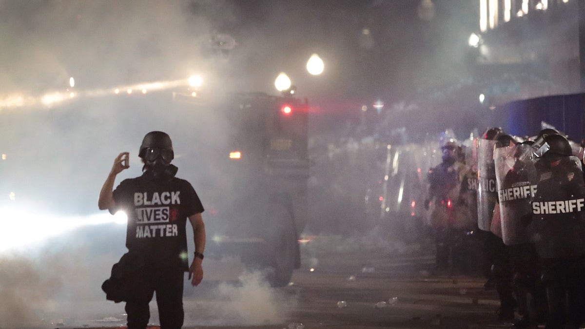 A Black lives matter protestor in Kenosha protests 