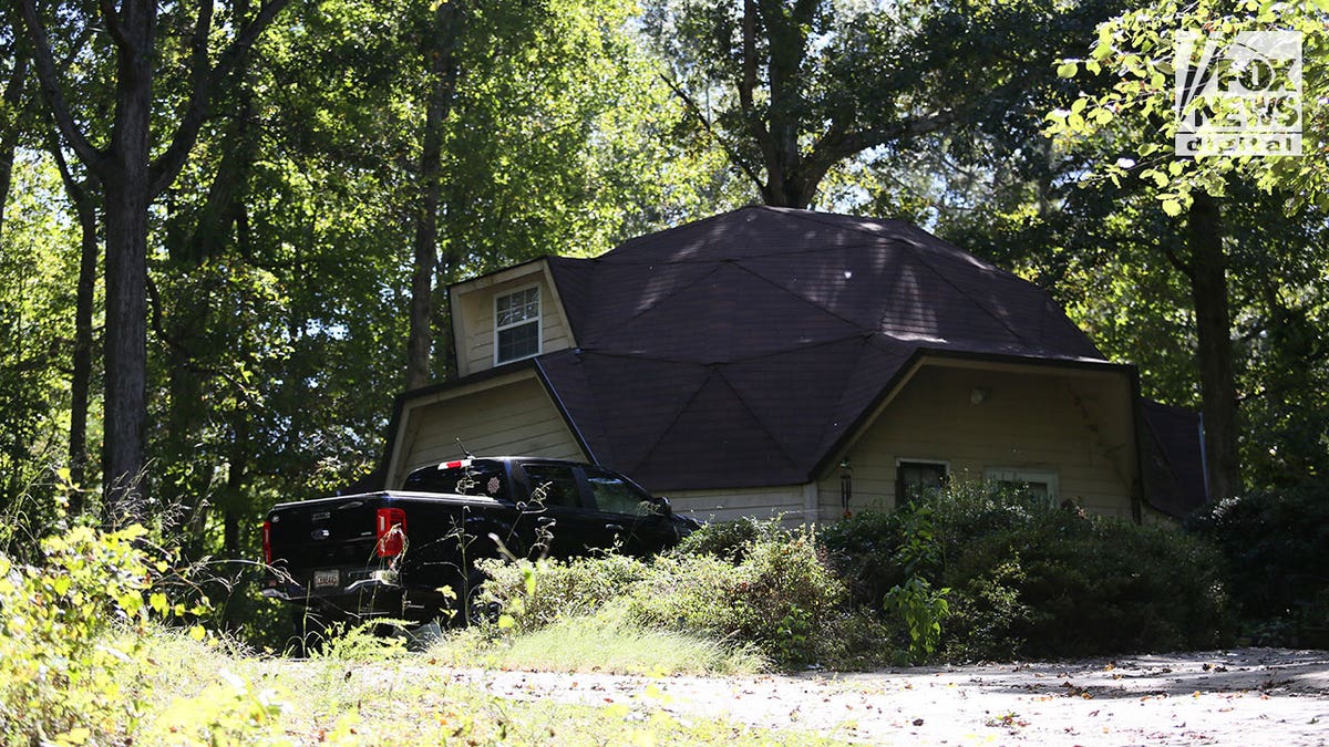 The home of Steven and Debbie Collier seen through some brush