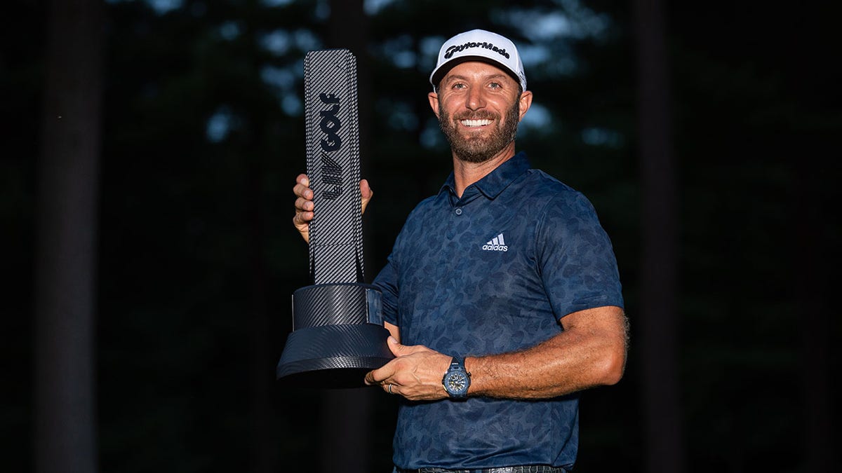 Dustin Johnson with LIV trophy