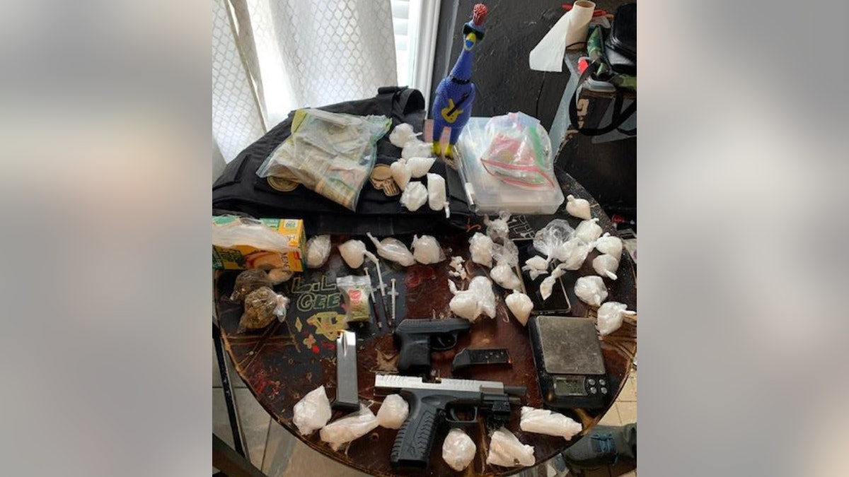drugs and guns seized on table