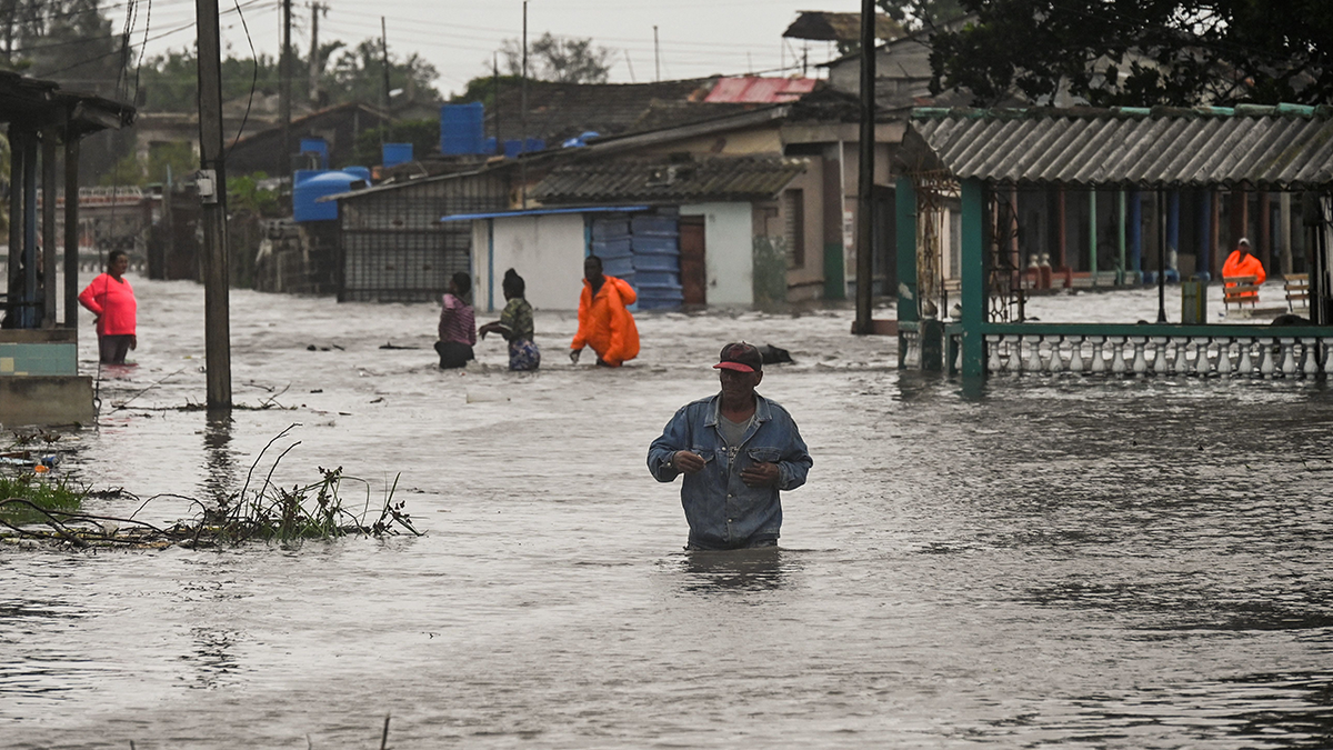 People walking through flooded streets