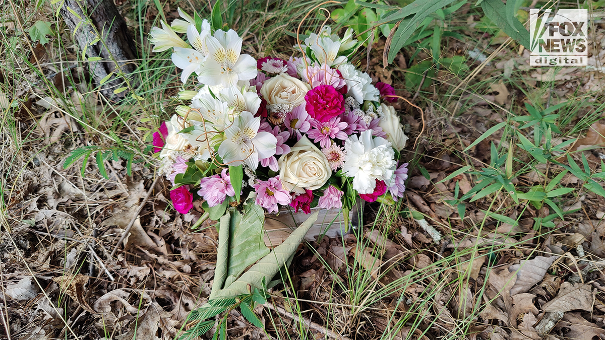 Flowers at the entrance to the crime scene where Debbie Collier was found dead.