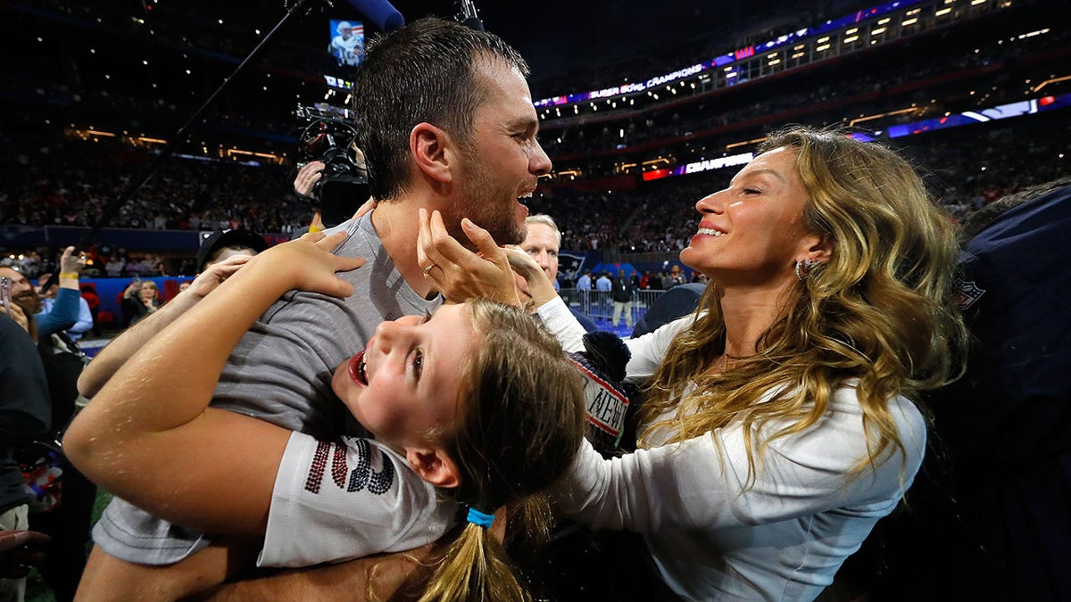 Tom Brady embraces Gisele Bundchen and his daughter after winning the Super Bowl in 2019
