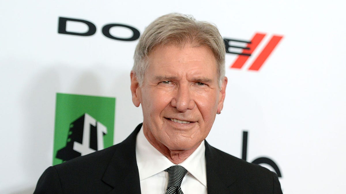 Harrison Ford smiling on the red carpet