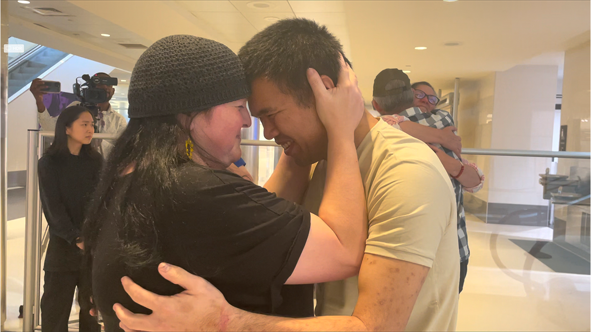 Andy Huynh hugs a loved one after returning home from fighting alongside Ukrainian forces