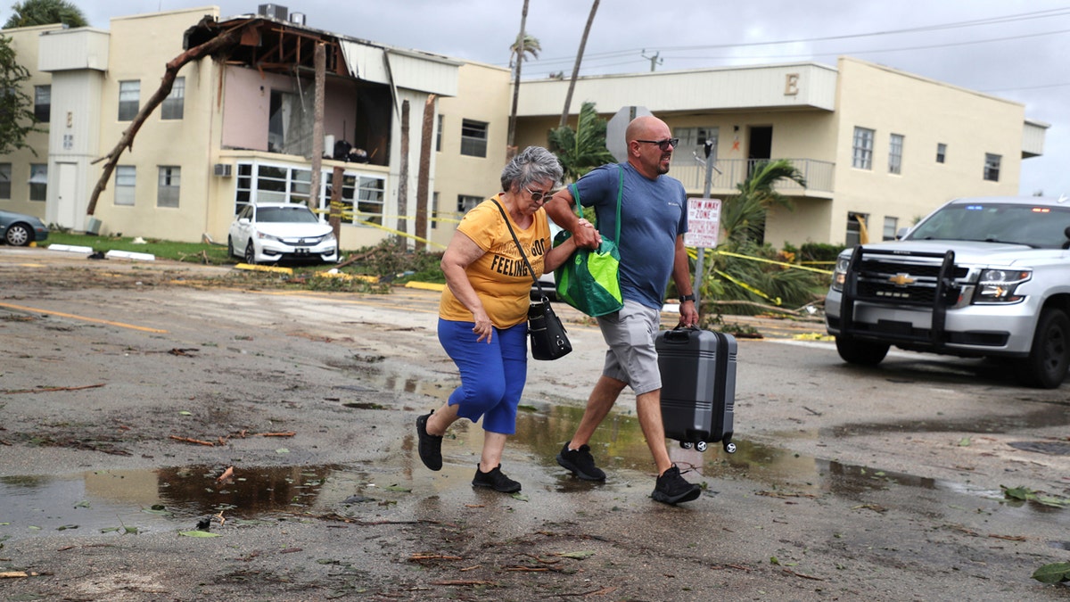 Florida residents walk through destroyed streets escaping Hurricane Ian damage