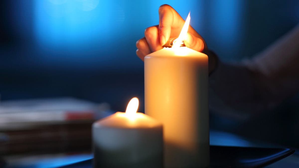 candle being lit in dark