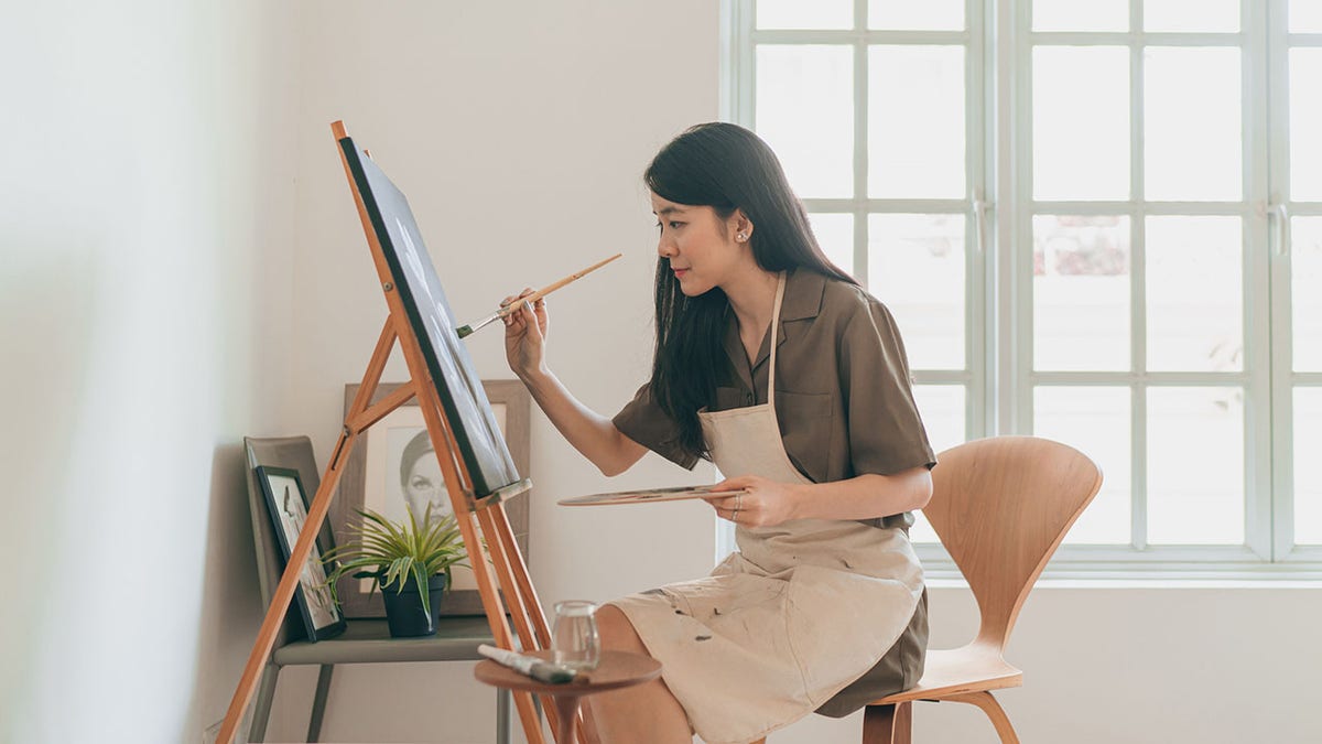 woman paints at home
