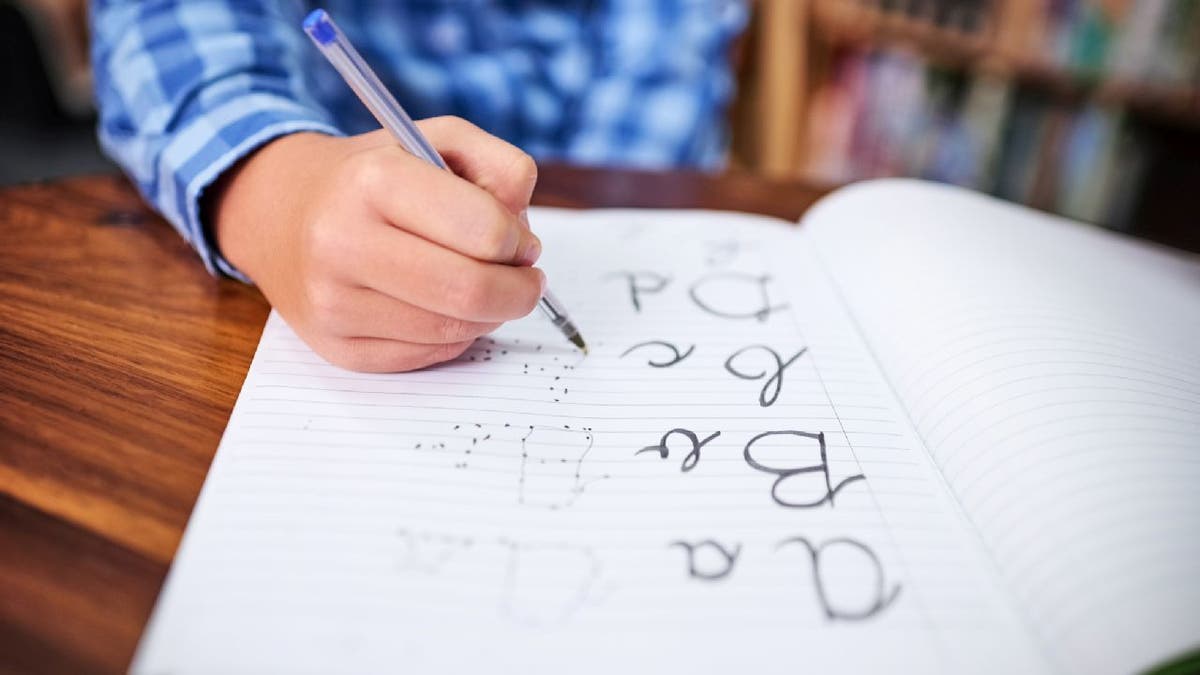 child practices cursive