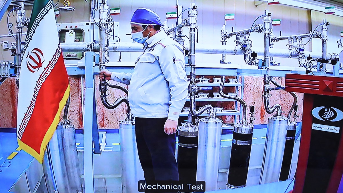 An engineer performs a mechanical test on nuclear equipment as President of Iran, Hassan Rouhani attends opening ceremony of nuclear projects in different regions of the country via video conference on 11th anniversary of National Nuclear Technology Day in Tehran, Iran on April 10, 2021.
