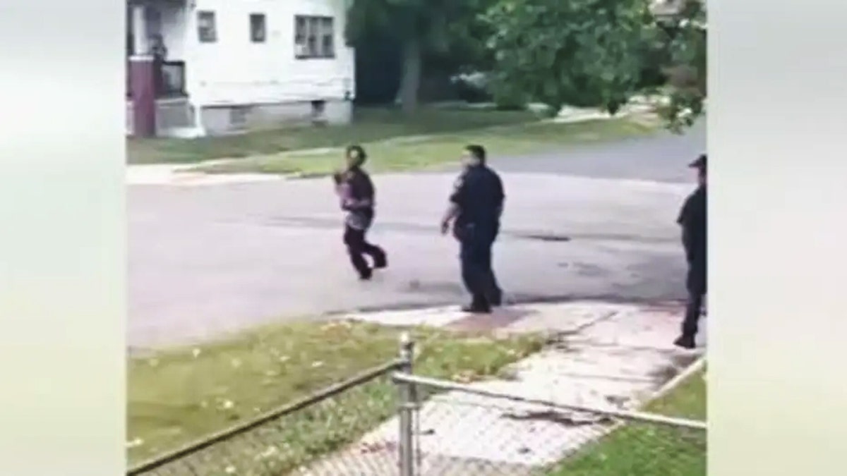 Irate barefoot man with baby in Detroit