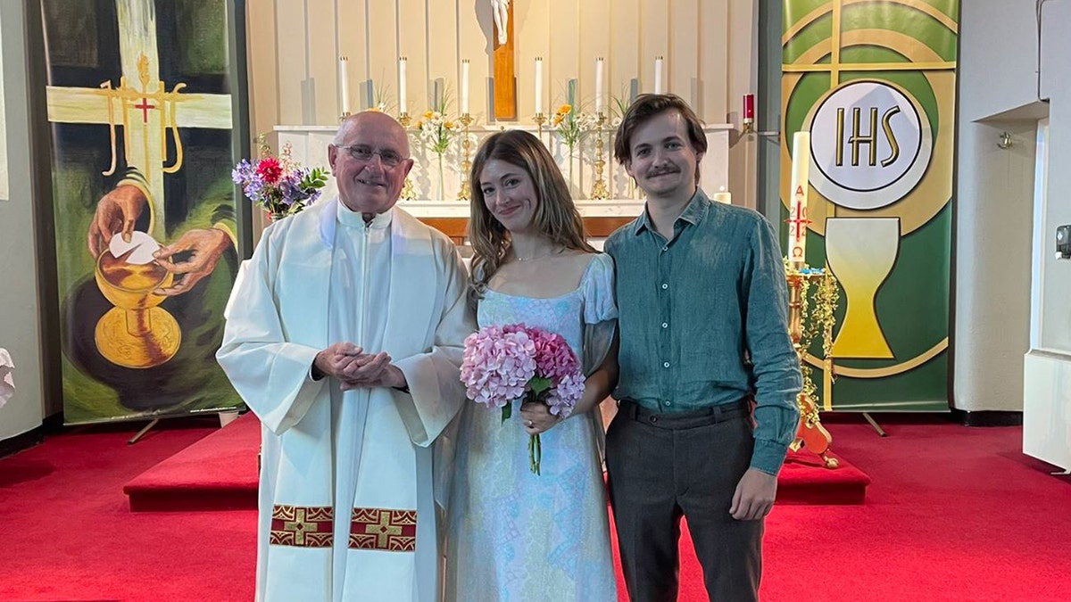 Jack Gleeson with Róisín O’Mahony and Father Patsy Lynch in front of the church's altar