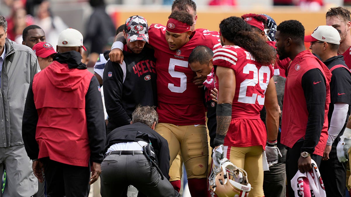 Trey Lance carried off field