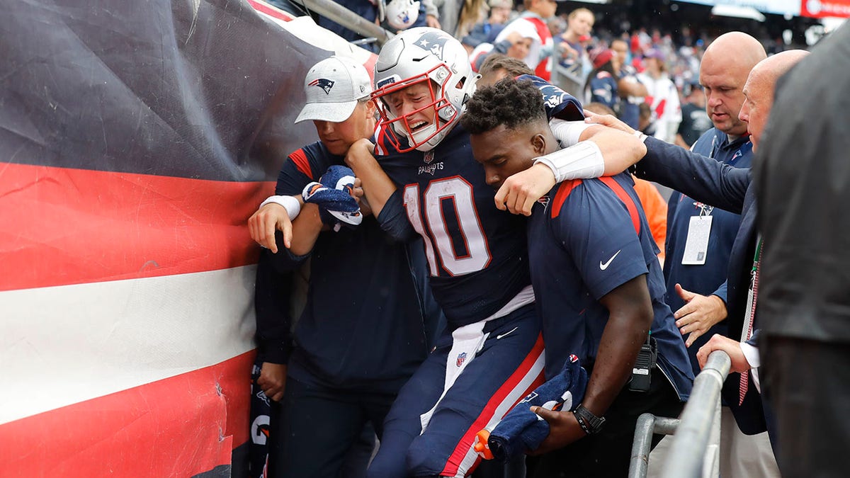 Mac Jones carried off field