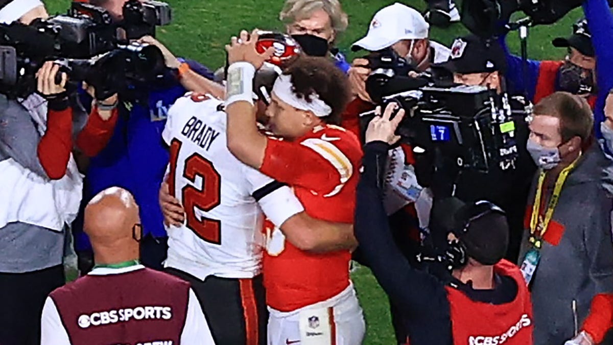 Tom Brady and Patrick Mahomes hug