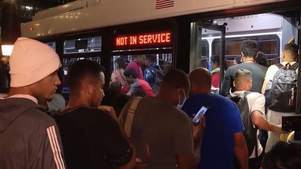 Migrants board bus in Chicago