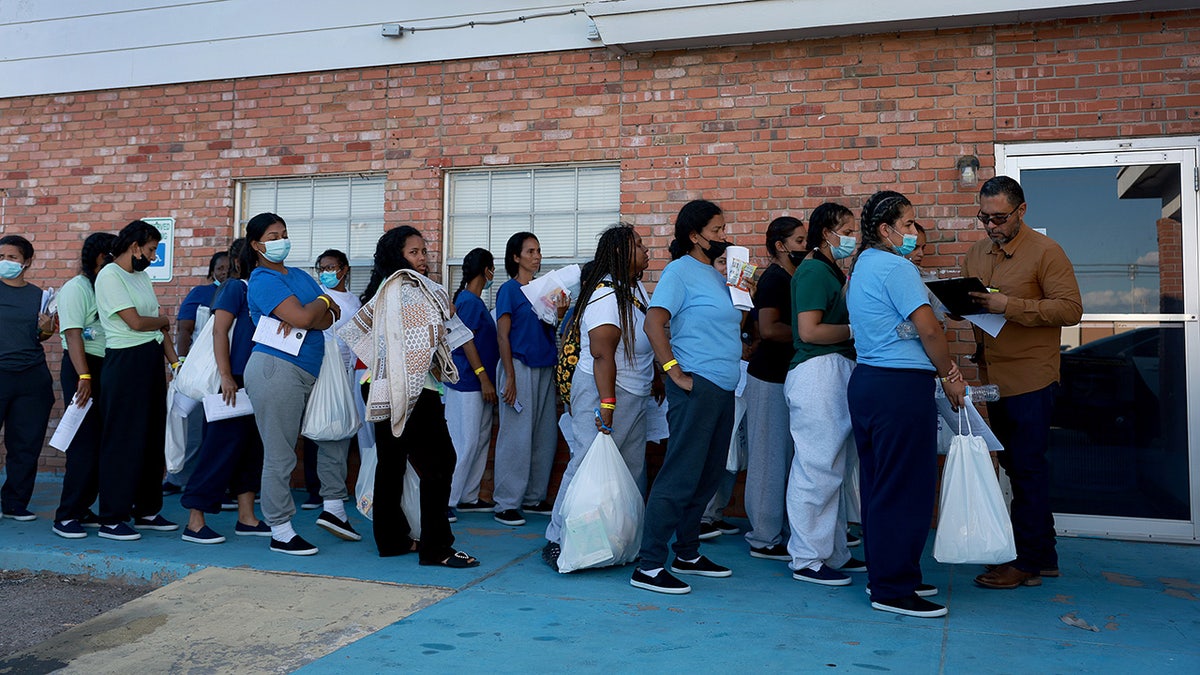 Migrants wait in line for rooms in El Paso Texas
