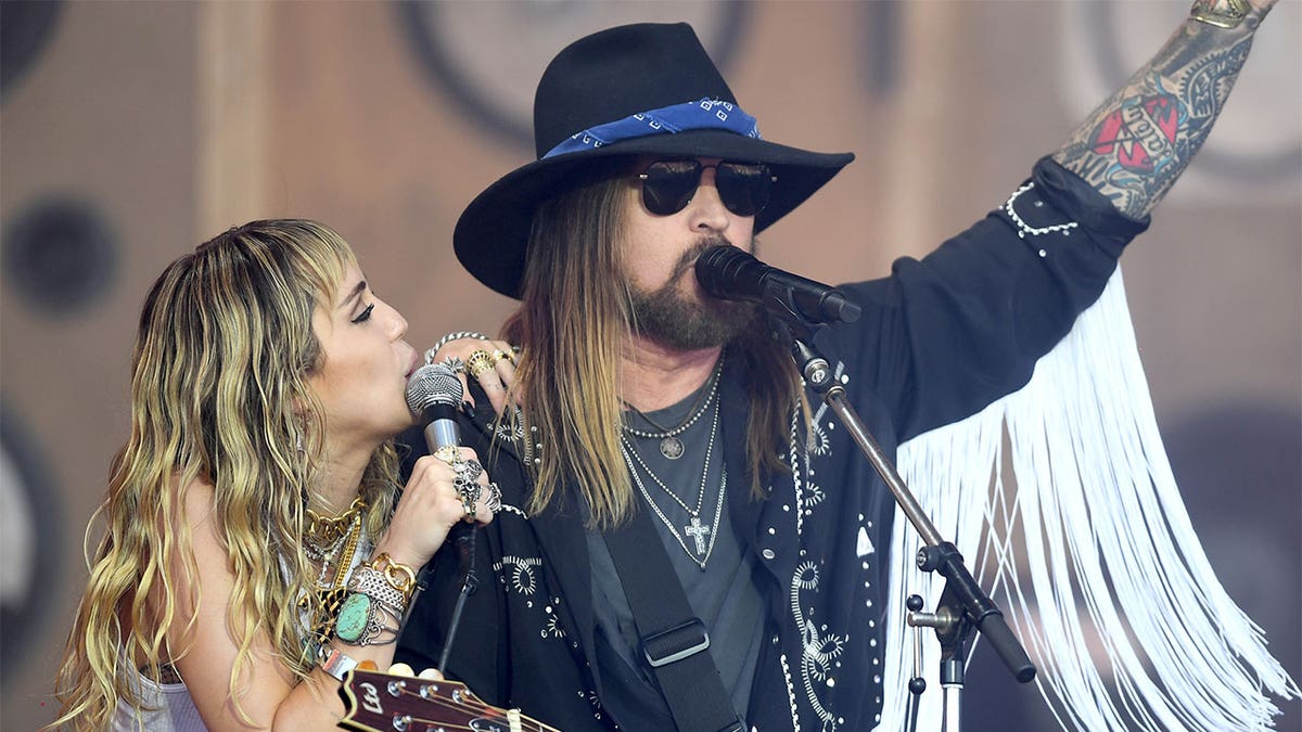 Miley Cyrus performs with Billy Ray Cyrus