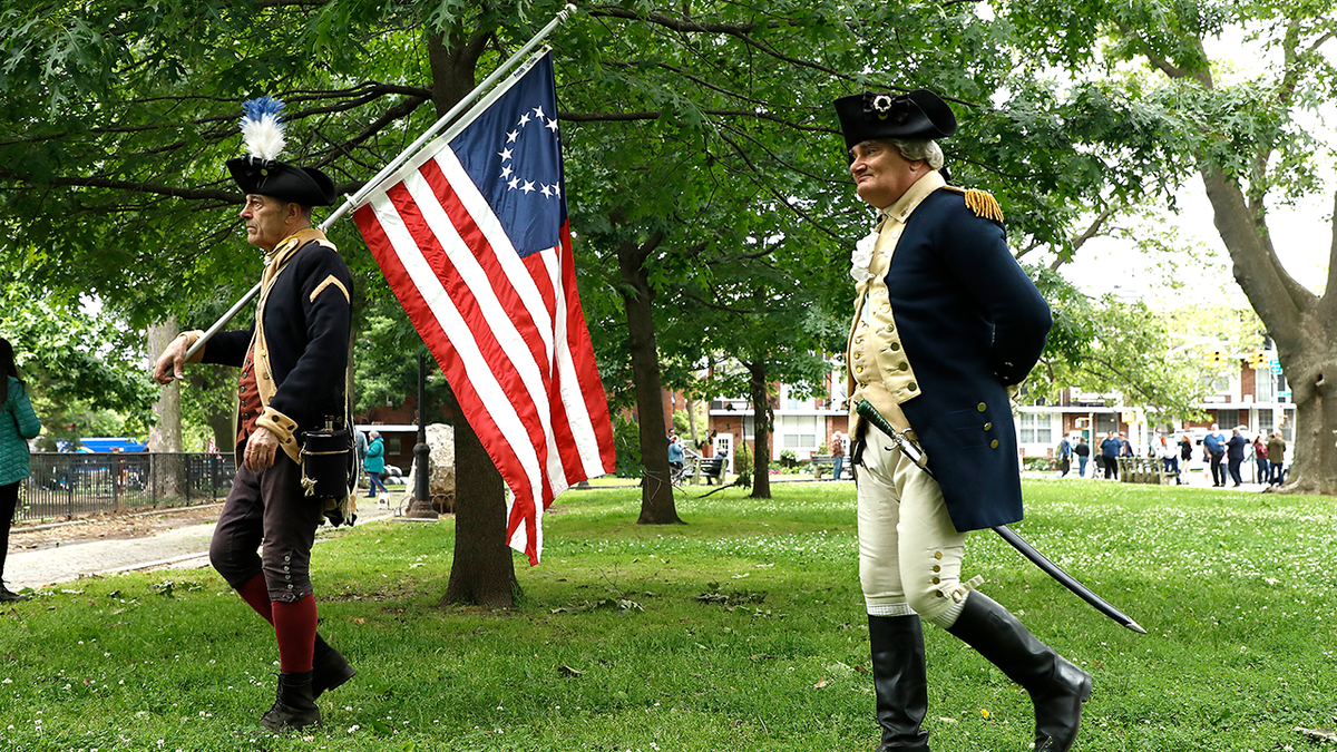 Men dressed as Revolutionary War fighters seen participating in reenactment in Brooklyn