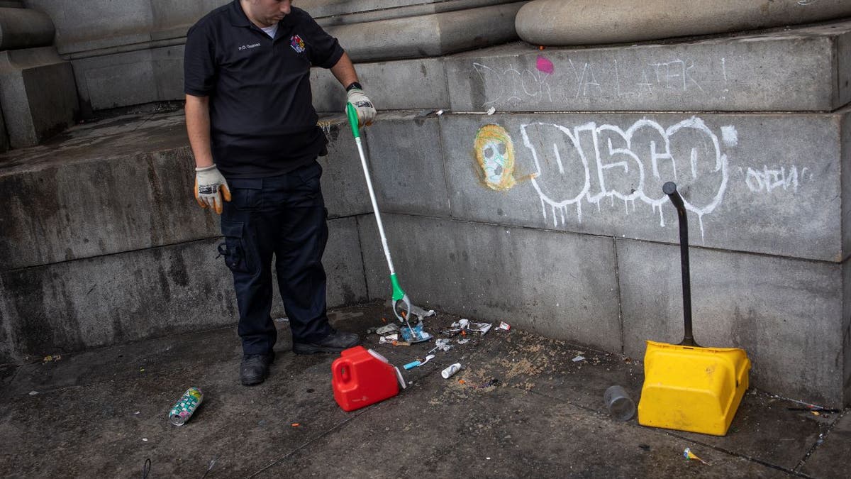 NYC sanitation worker picks up used drug needles
