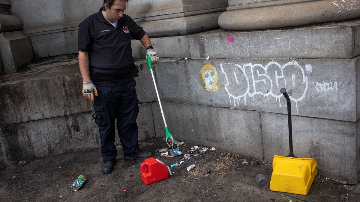 NYC sanitation worker picks up used drug needles