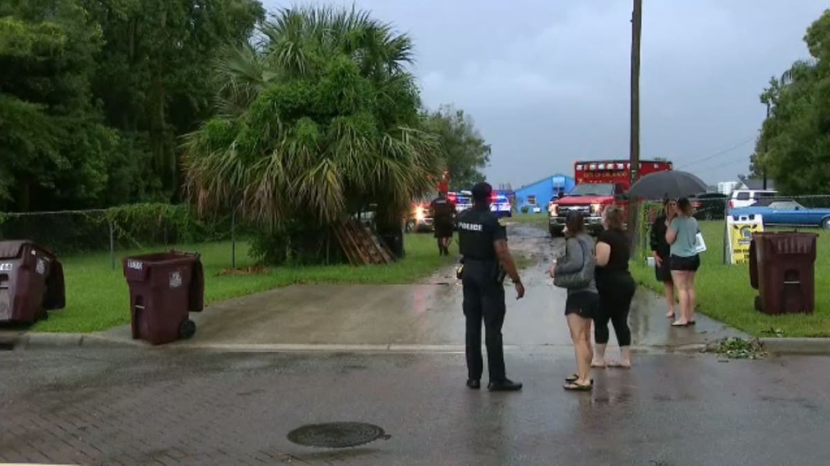 A police officer talking to a couple of women outside in Florida