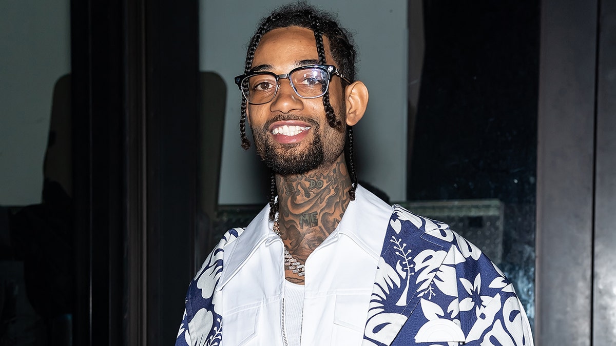 PnB Rock wearing a blue and white shirt before he was shot and killed in a robbery in LA