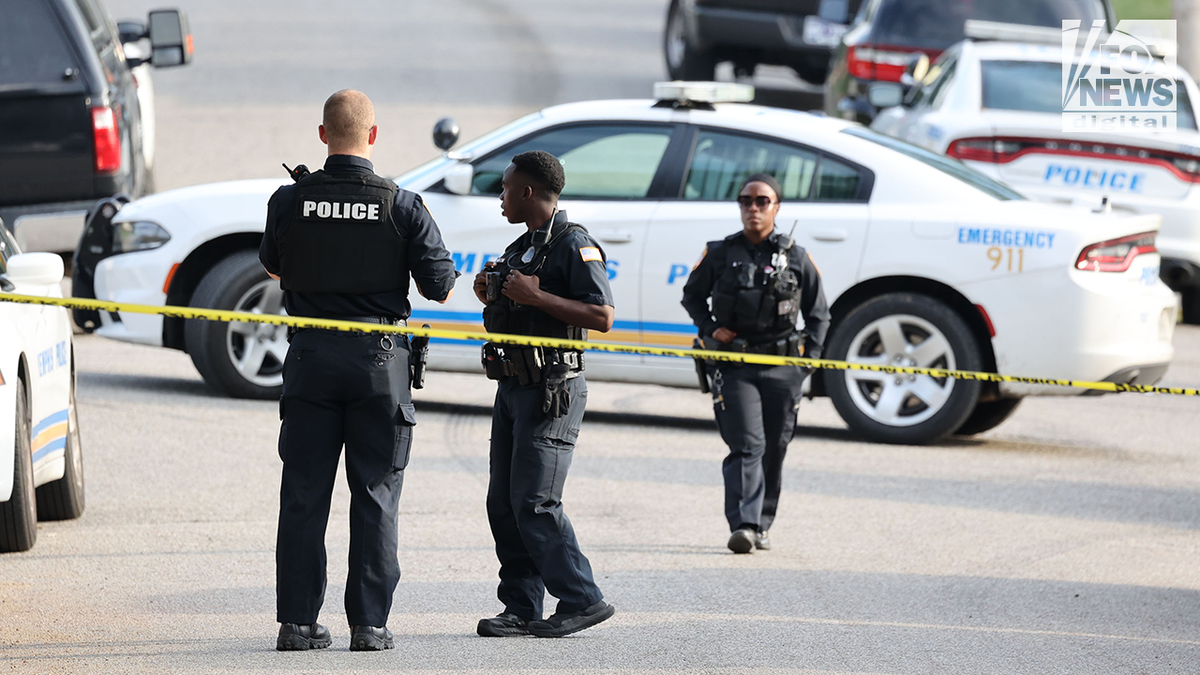 Police officers outside the home of Mario Abston