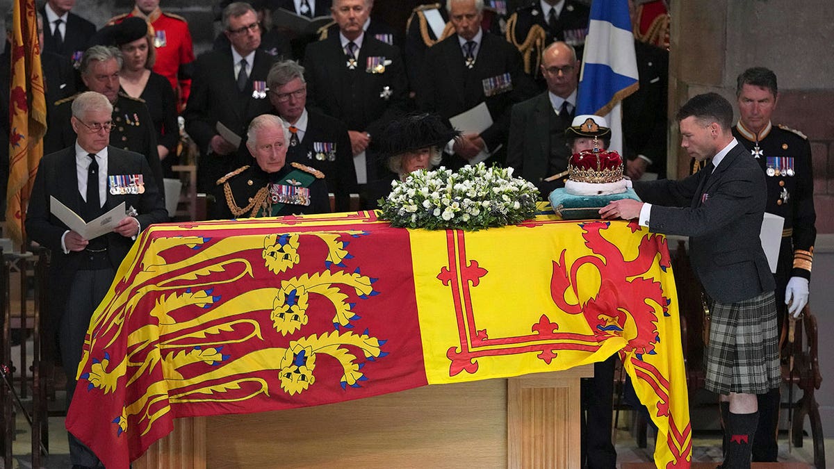 Queen Elizabeth's coffin draped with a flag