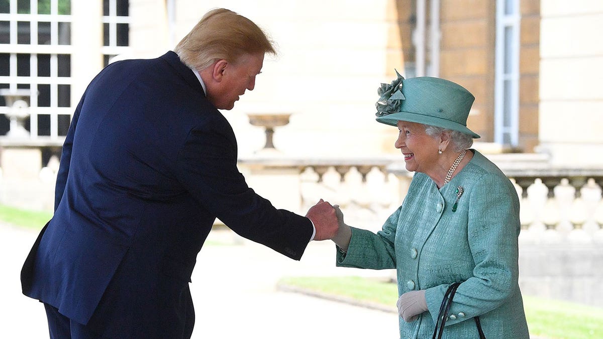 Former President Trump fistbumps Queen Elizabeth, wearing a turqouise dress and hat