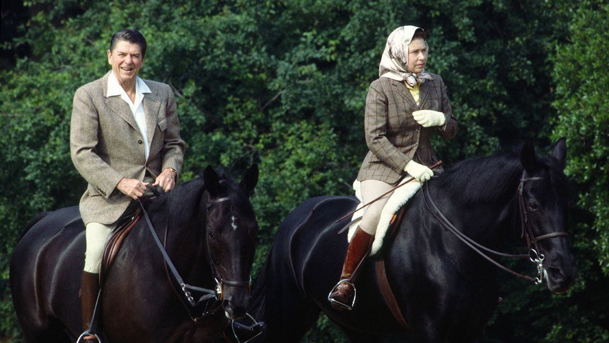 Queen Elizabeth and President Ronald Reagan ride horses outside