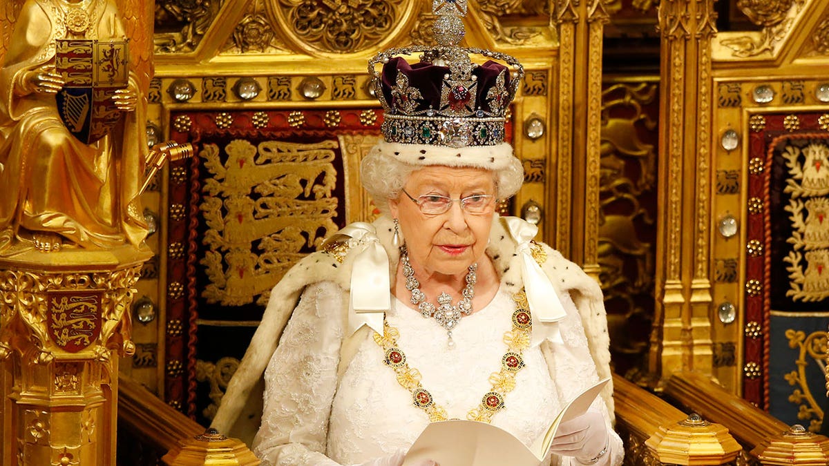 Queen Elizabeth II sits in her full regal ensemble