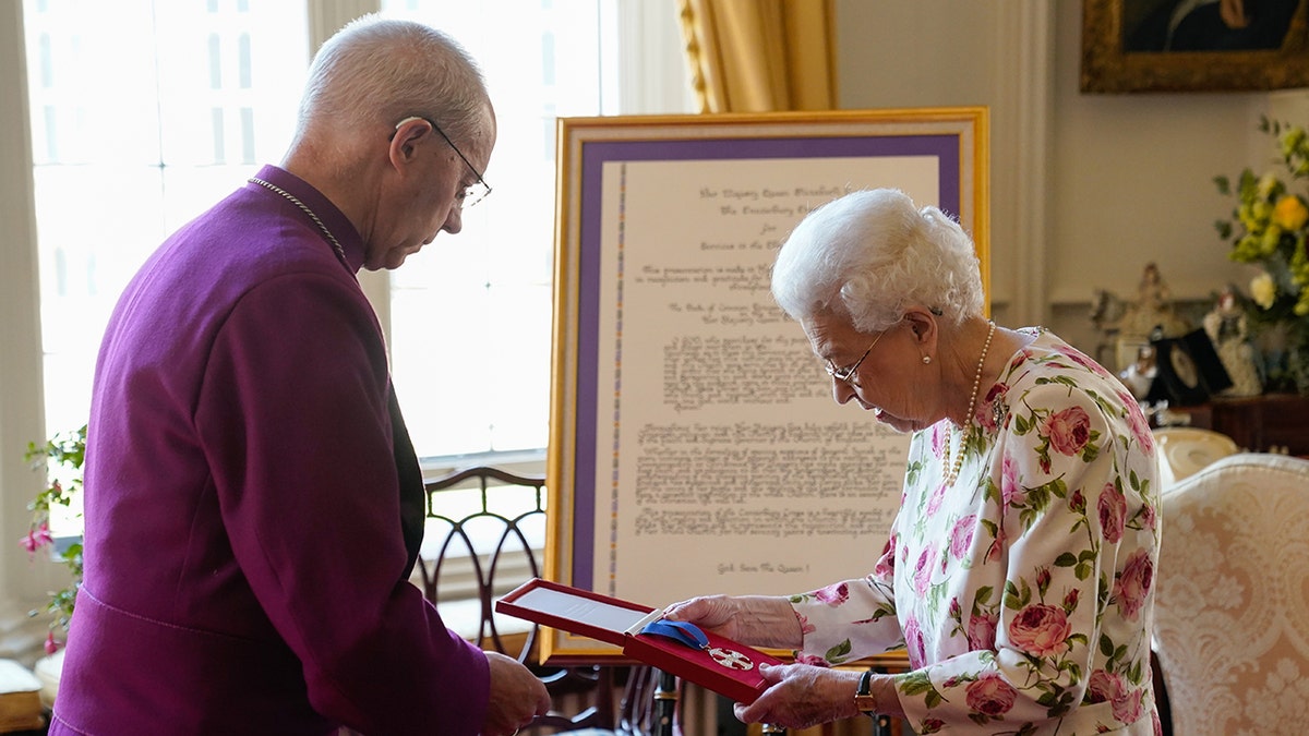 The queen holds her Canterbury Cross awarded by the archbishop