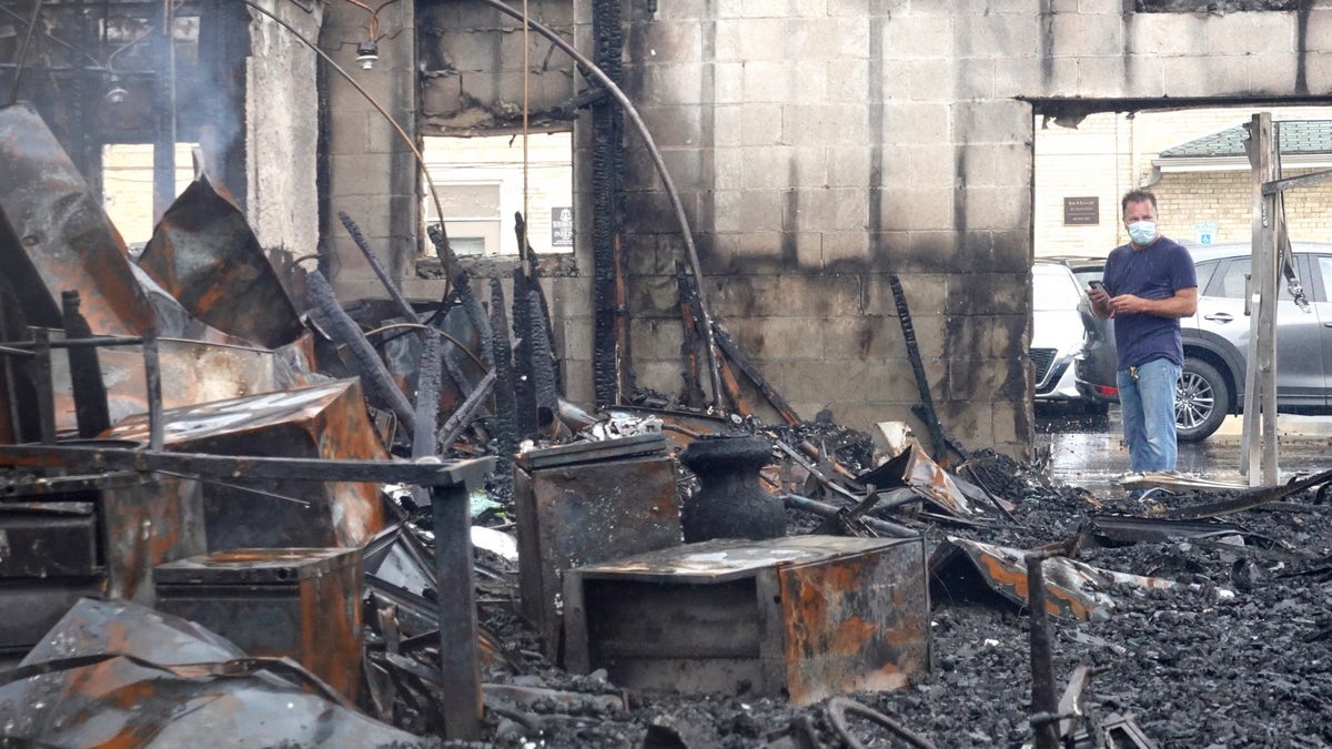 Kenosha businessman stands in front of store burnt down in 2020 protests