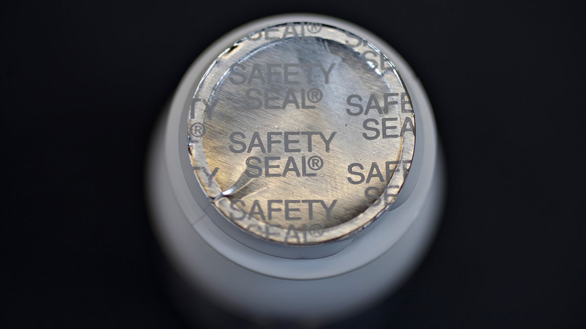 A tin foil safety seal on a Tylenol bottle