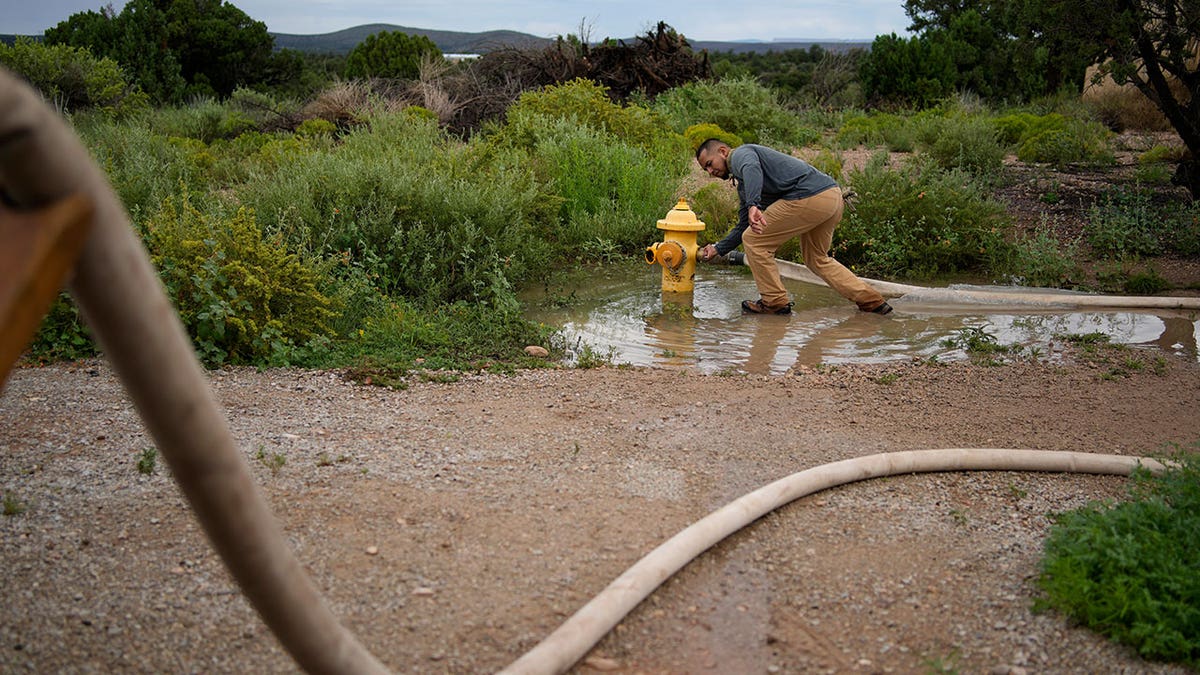 Man fills water truck on the Hualapai reservation