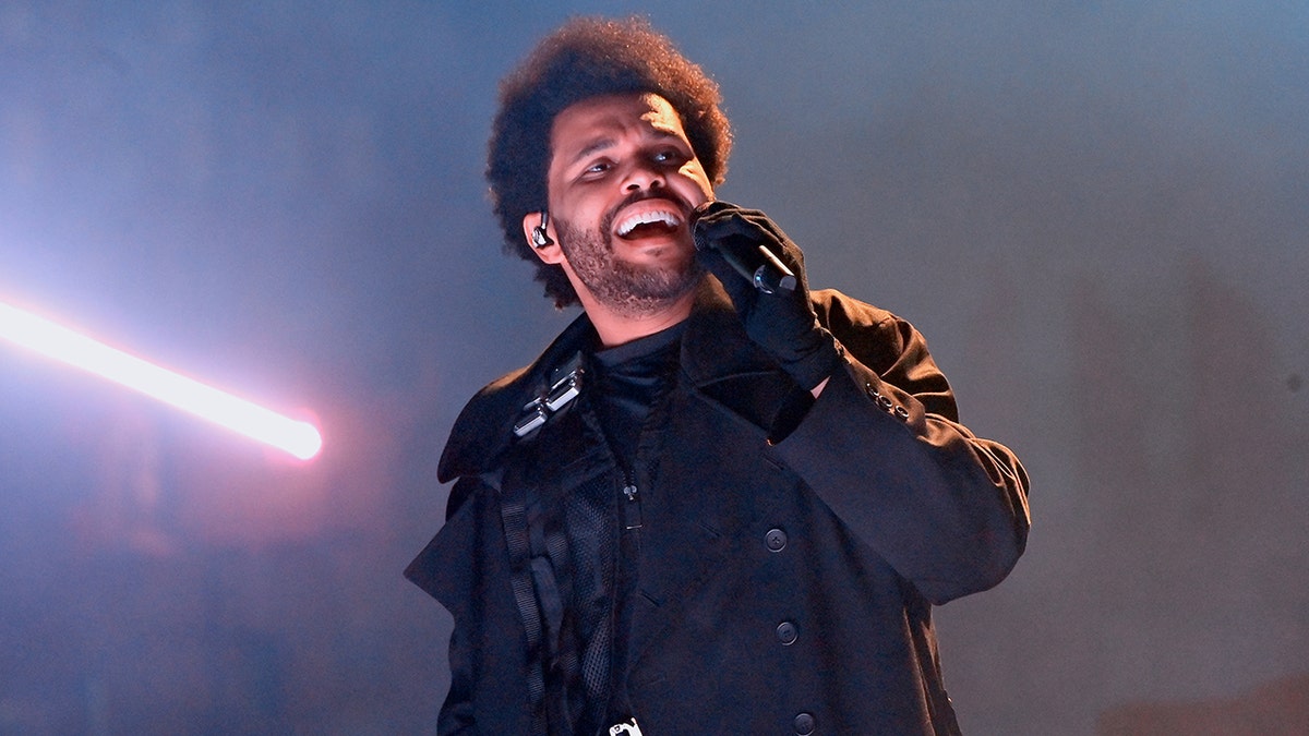 The Weeknd sings on stage
