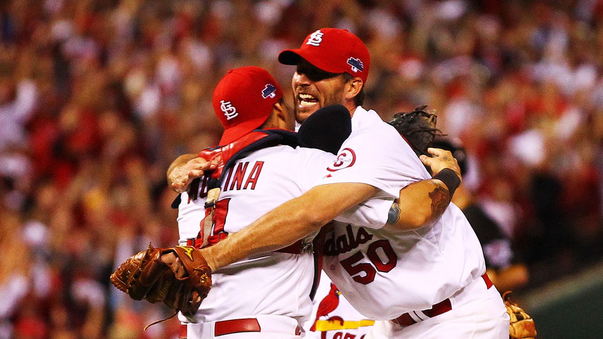 Yadier Molina and Adam Wainwright hug