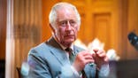 King Charles III sitting during a meeting
