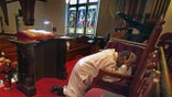 Photo of pastor praying in church